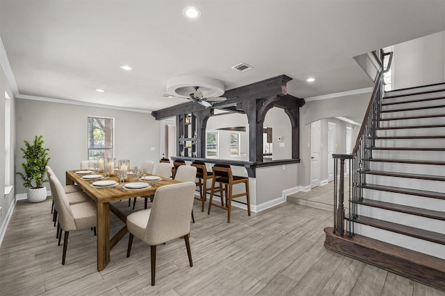 dining space featuring ceiling fan and ornamental molding