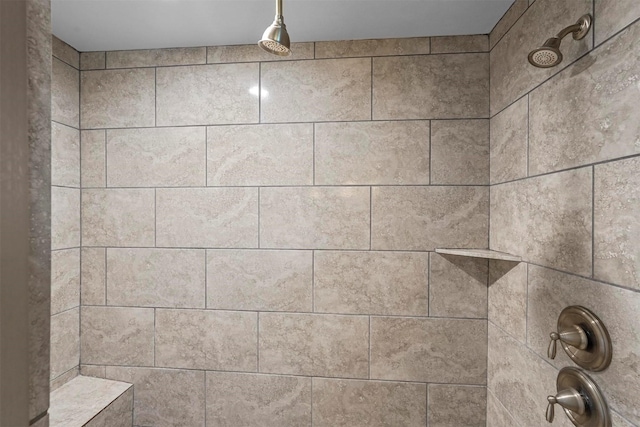 interior details featuring a tile shower