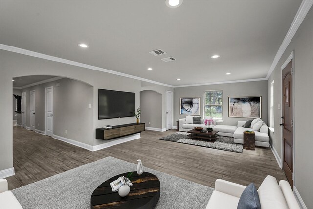 living room featuring wood-type flooring and ornamental molding