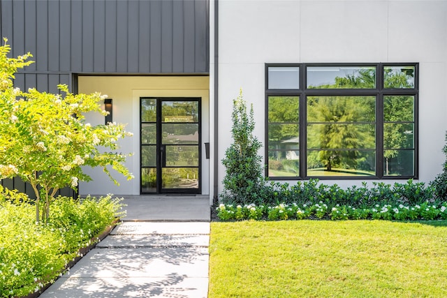 doorway to property with a yard