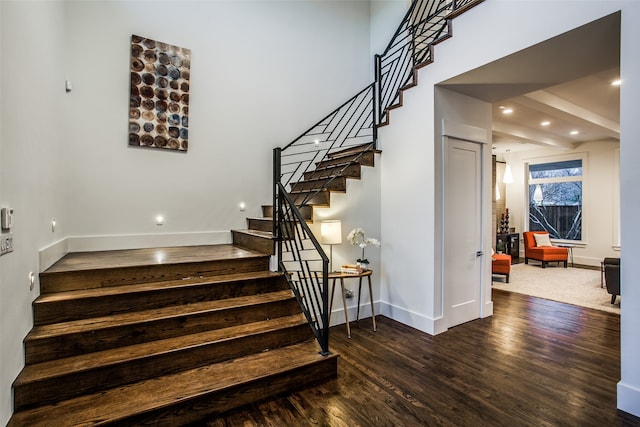 stairway featuring wood-type flooring