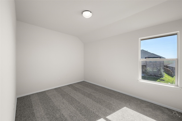 unfurnished room with carpet and lofted ceiling