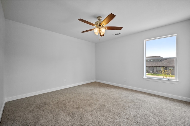 empty room with ceiling fan and carpet flooring