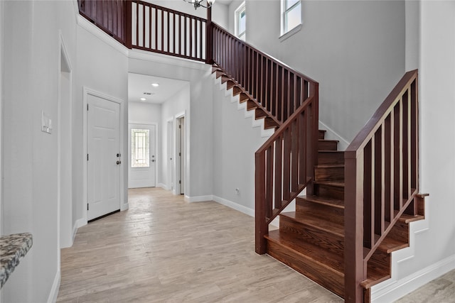 interior space featuring a high ceiling, hardwood / wood-style floors, and a wealth of natural light