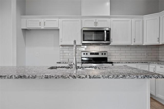 kitchen featuring white cabinets, hardwood / wood-style flooring, stainless steel appliances, and sink