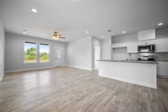 kitchen with stainless steel appliances, light hardwood / wood-style floors, ceiling fan, and white cabinets