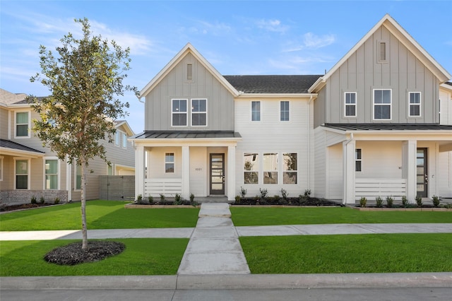 view of front facade with a front lawn and covered porch