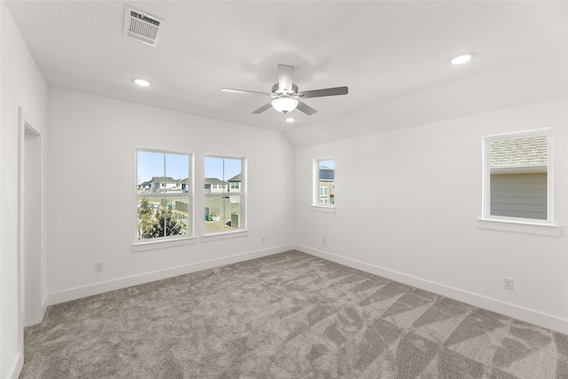 spare room featuring ceiling fan, carpet, and vaulted ceiling