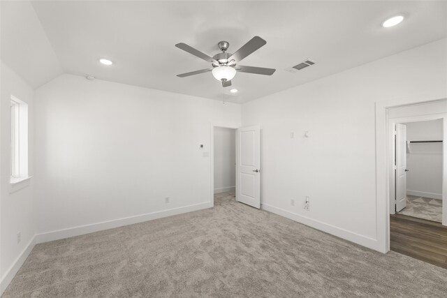 unfurnished bedroom with ceiling fan, carpet floors, and vaulted ceiling