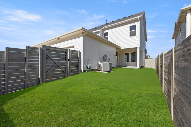 back of property featuring a yard and cooling unit