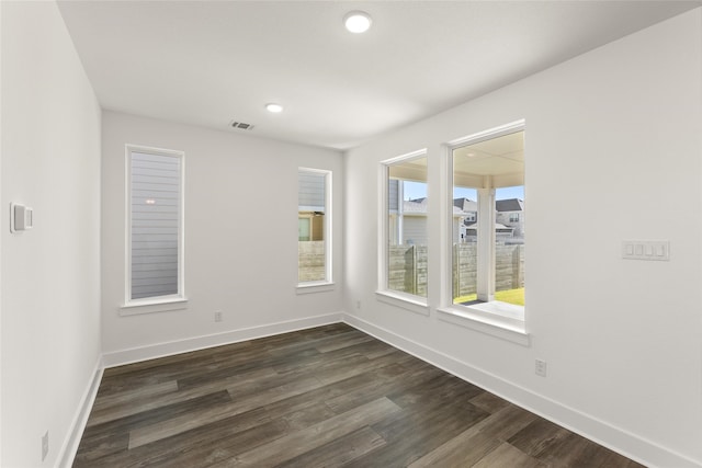 spare room with dark hardwood / wood-style flooring