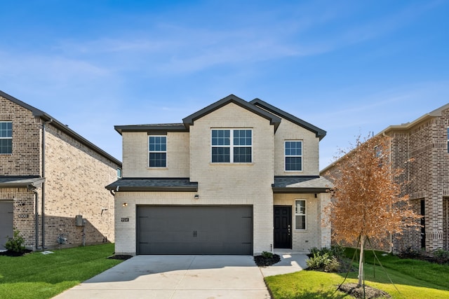 view of property with a front lawn and a garage