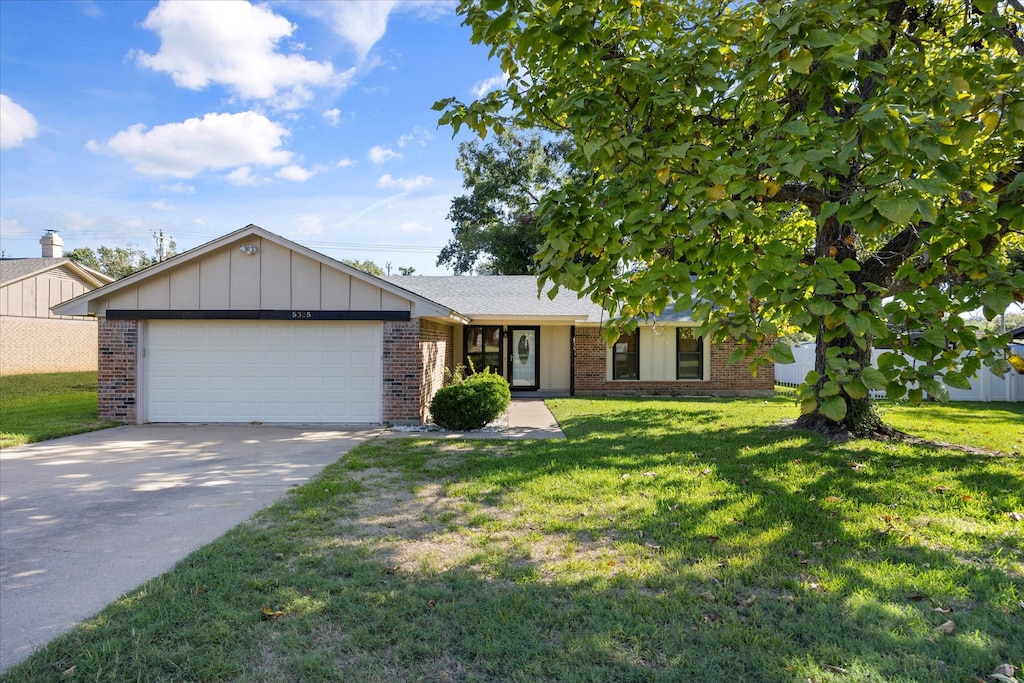 ranch-style home with a front lawn and a garage