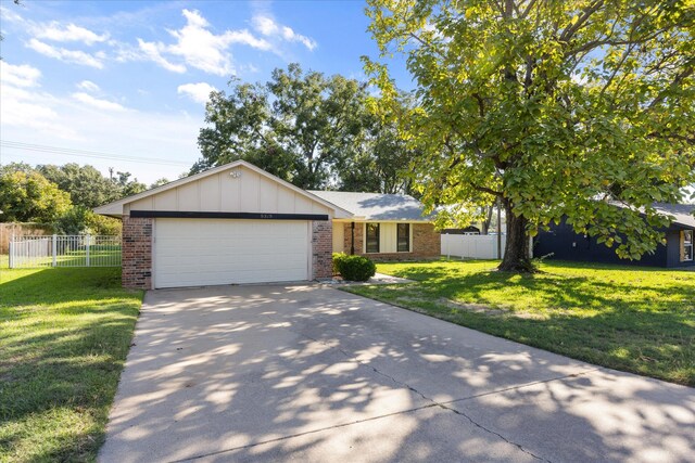 ranch-style home featuring a garage and a front yard