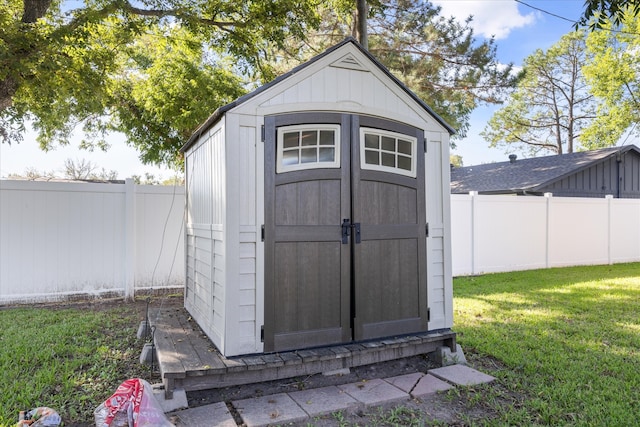 view of outbuilding featuring a yard