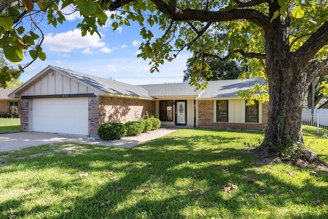 ranch-style home featuring a garage and a front lawn