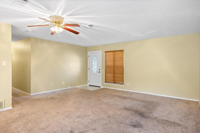 empty room featuring light carpet and ceiling fan