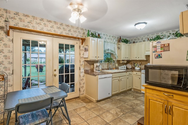 kitchen featuring light tile patterned flooring, sink, backsplash, white dishwasher, and ceiling fan