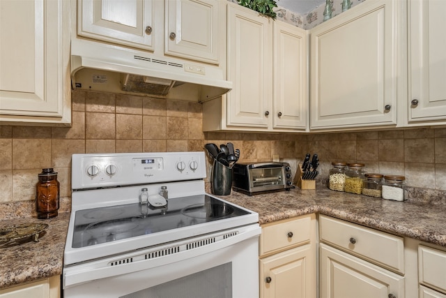 kitchen with decorative backsplash, electric stove, and cream cabinetry