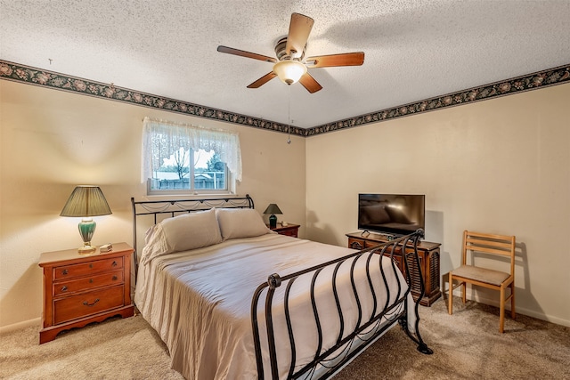 bedroom featuring a textured ceiling, ceiling fan, and light colored carpet