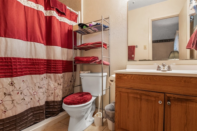 bathroom with walk in shower, vanity, toilet, and tile patterned floors