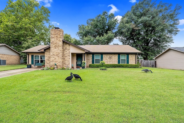 ranch-style house featuring central AC and a front yard