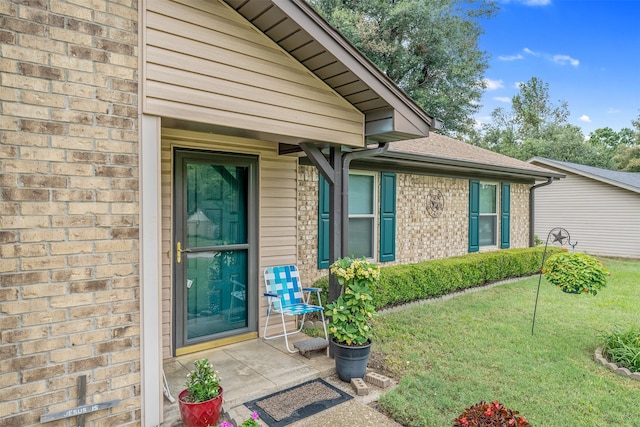 doorway to property with a yard