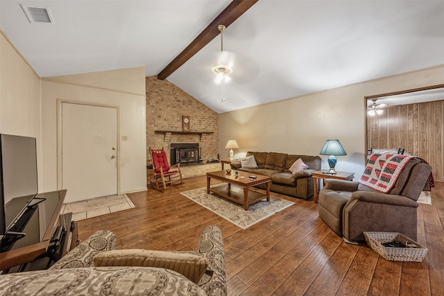 living room featuring a fireplace, lofted ceiling with beams, dark wood-type flooring, and ceiling fan