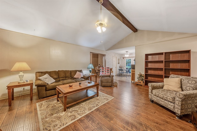 living room featuring high vaulted ceiling, beam ceiling, an inviting chandelier, and hardwood / wood-style floors