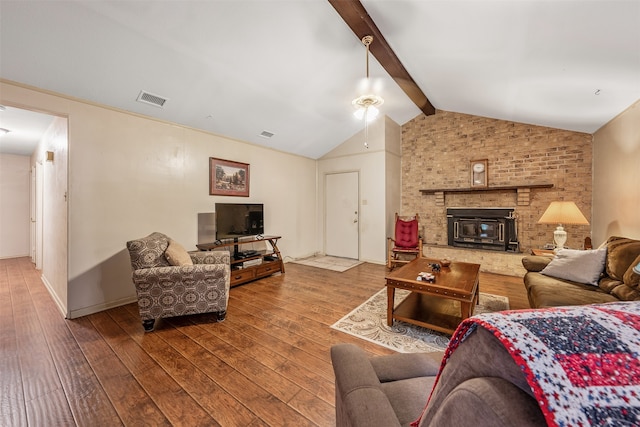 living room with wood-type flooring, vaulted ceiling with beams, and a fireplace