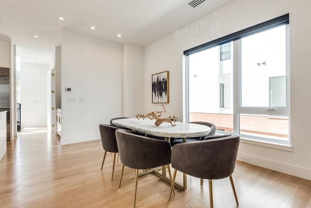 dining area with light hardwood / wood-style floors