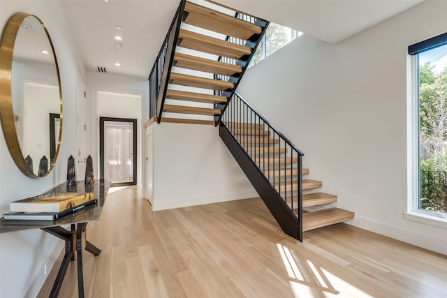 staircase with hardwood / wood-style flooring