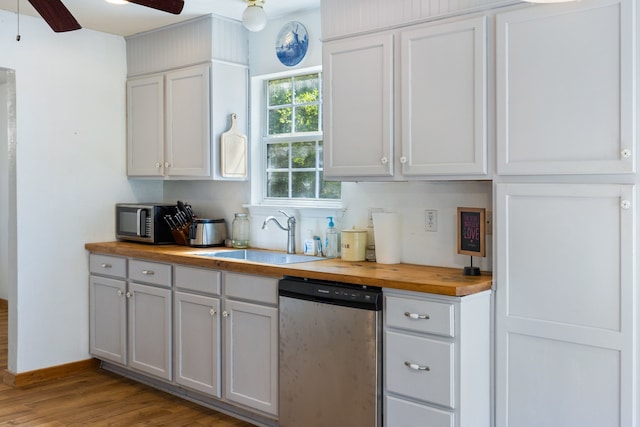 kitchen featuring light wood-type flooring, sink, appliances with stainless steel finishes, ceiling fan, and butcher block countertops