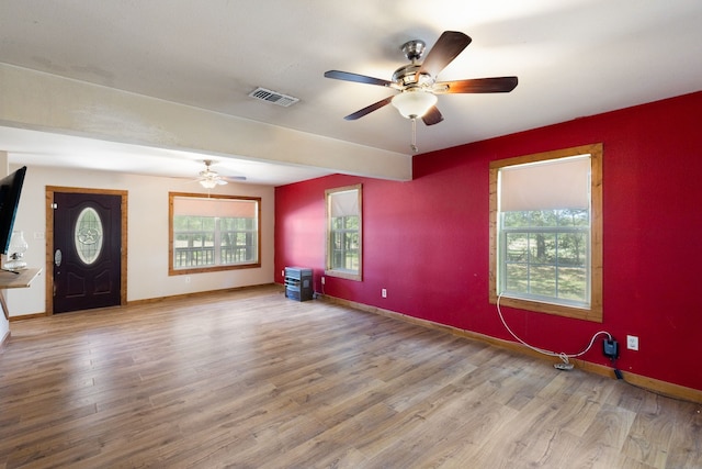 interior space featuring hardwood / wood-style flooring, ceiling fan, and plenty of natural light