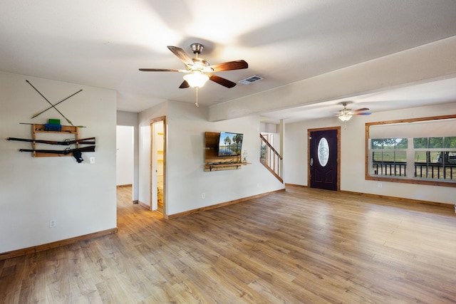 unfurnished living room with ceiling fan and light wood-type flooring