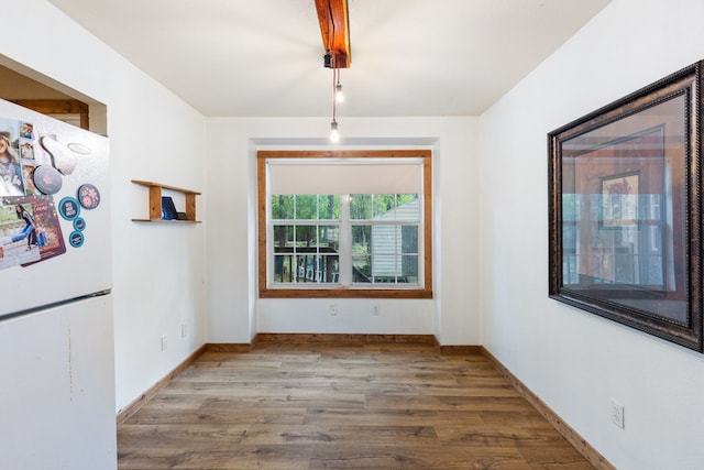 unfurnished dining area featuring hardwood / wood-style flooring