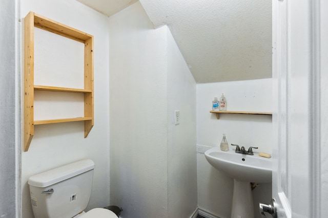 bathroom with a textured ceiling and toilet