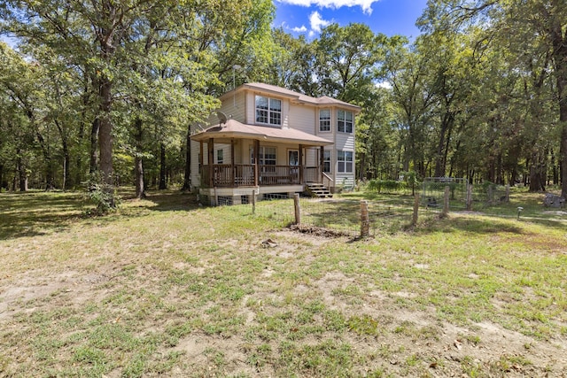 view of front of house with covered porch and a front yard