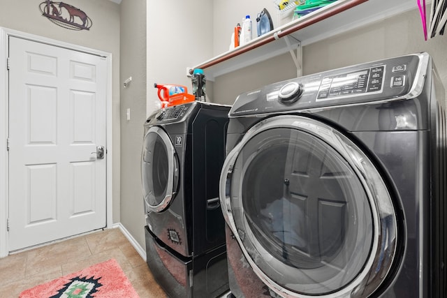 washroom with light tile patterned flooring and washing machine and dryer