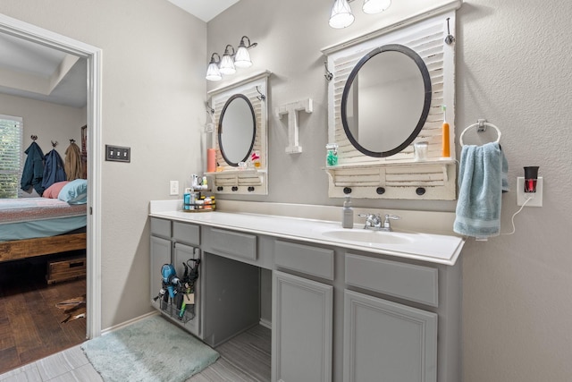9433 Drovers View Trl, Fort Worth, TX 76131 - ensuite bathroom featuring baseboards, wood finished floors, vanity, and ensuite bathroom
