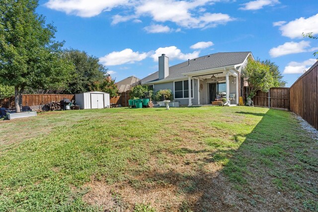 9433 Drovers View Trl, Fort Worth, TX 76131 - rear view of house featuring an outdoor structure, a yard, a fenced backyard, a chimney, and a storage unit