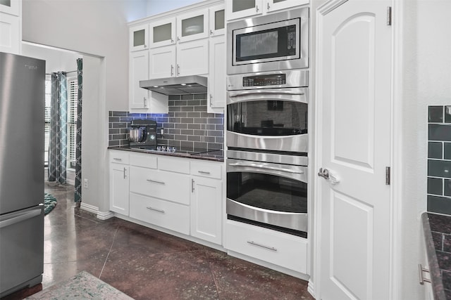 kitchen featuring appliances with stainless steel finishes, decorative backsplash, and white cabinetry