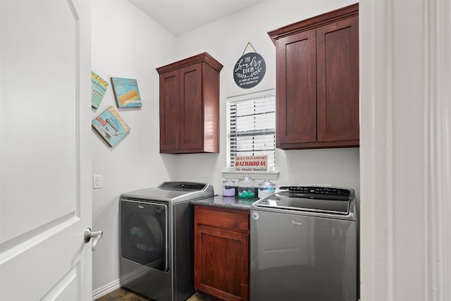 clothes washing area featuring cabinets and washer and dryer