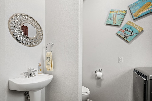 bathroom featuring sink and toilet