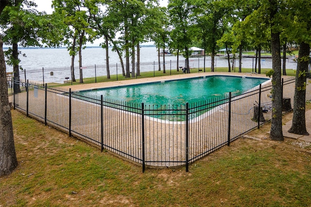 view of swimming pool with a yard and a water view