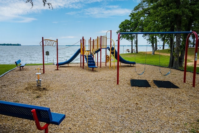 view of jungle gym featuring a water view and a yard