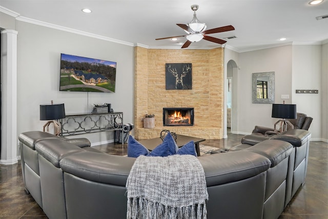 living room featuring crown molding, a stone fireplace, and ceiling fan