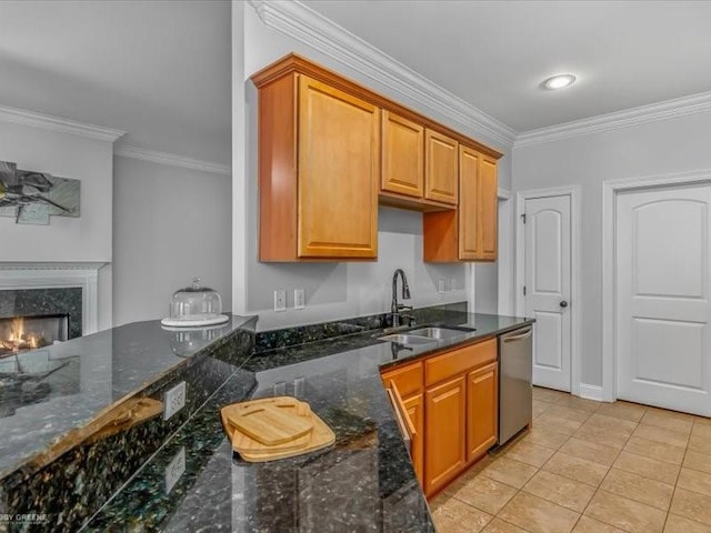 kitchen with sink, a fireplace, ornamental molding, light tile patterned floors, and stainless steel dishwasher