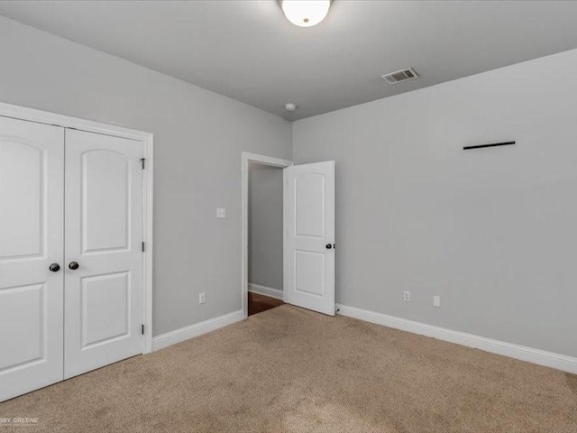 unfurnished bedroom featuring a closet and carpet