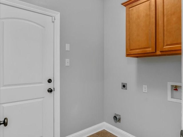 laundry area with tile patterned flooring, electric dryer hookup, washer hookup, and cabinets